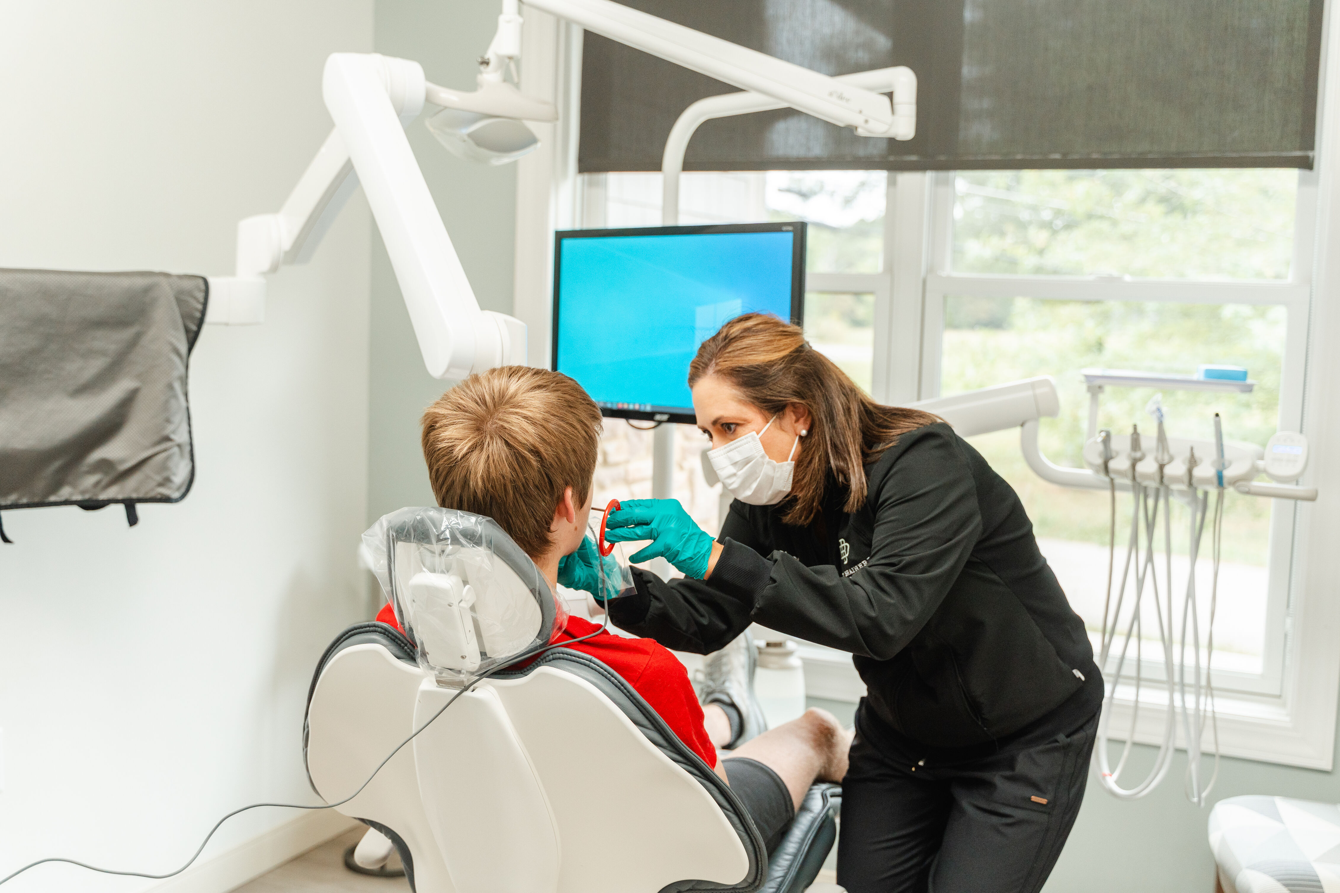 hygienist with pediatric patient